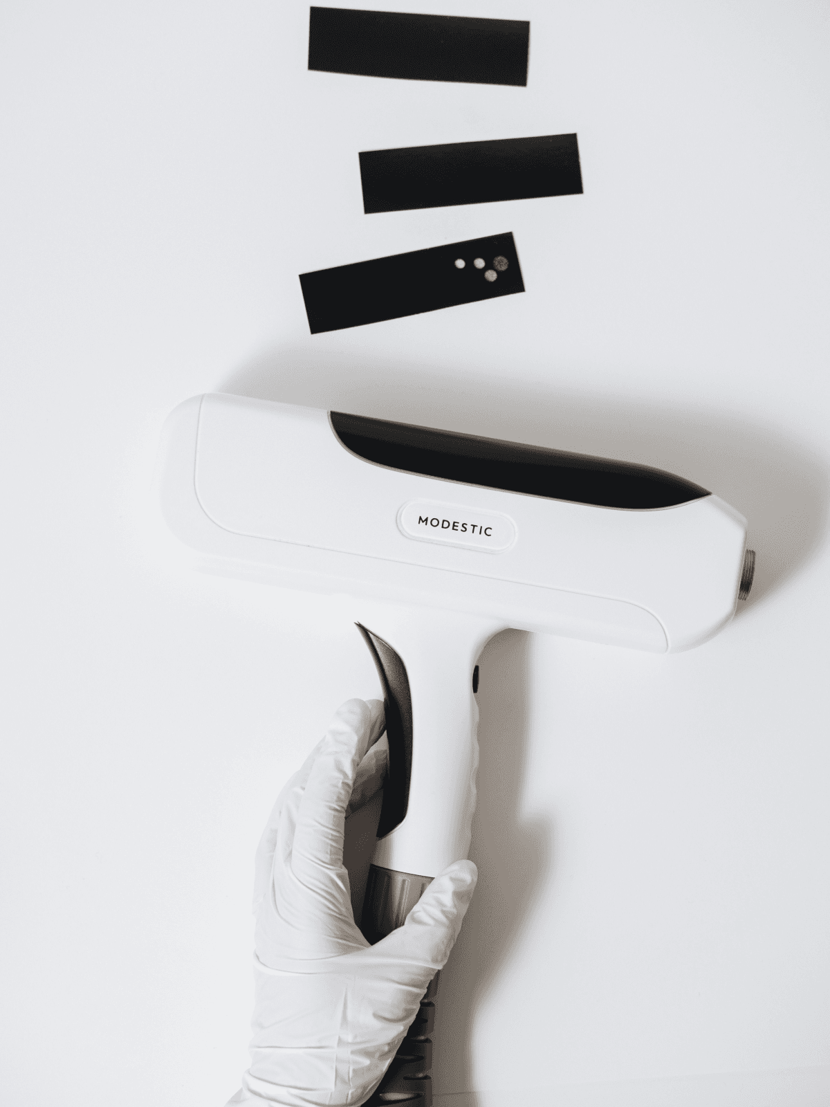 Modestic laser in a gloved hand — service and support