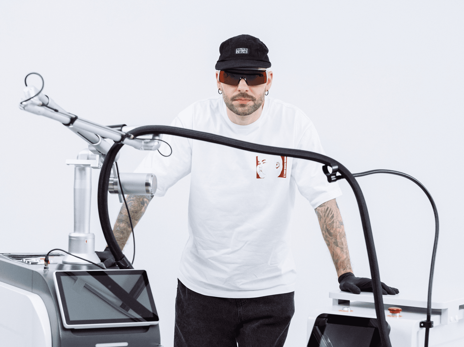 A tattoo artist at the Modestic Edge laser with its cooling module