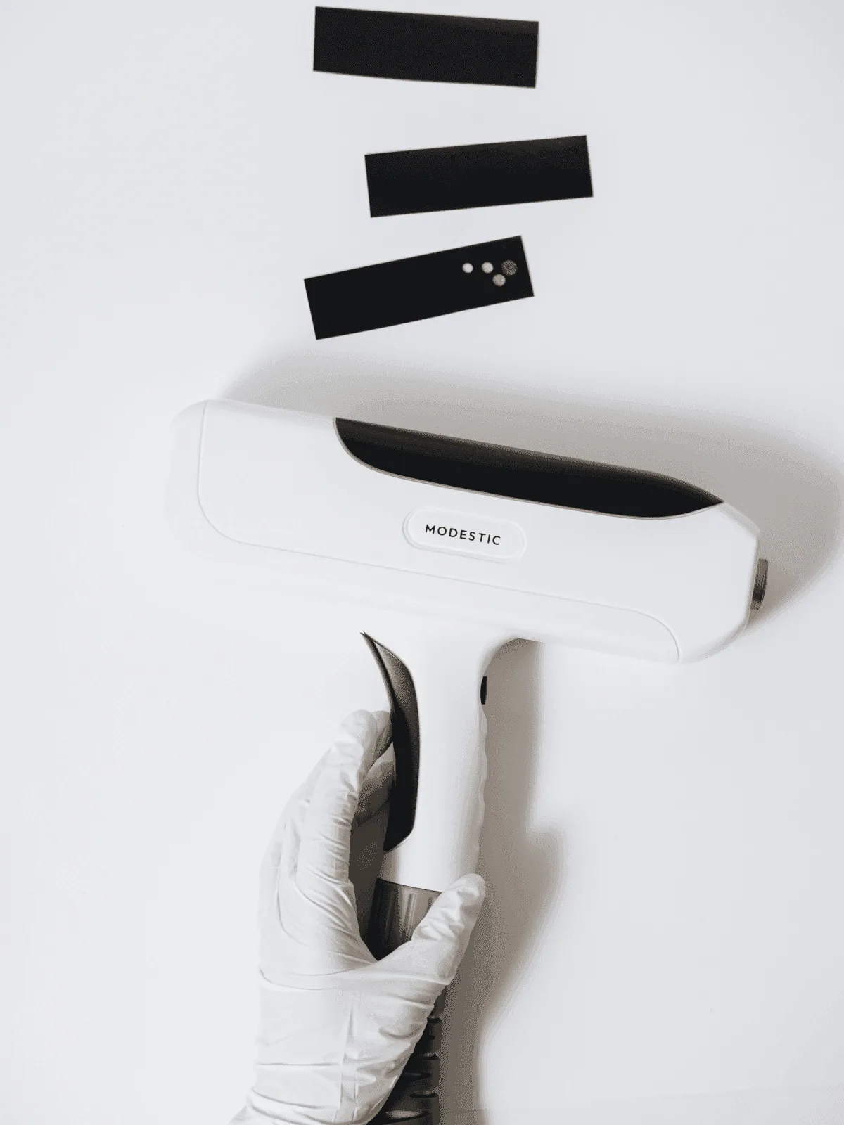 Modestic laser in a gloved hand — service and support